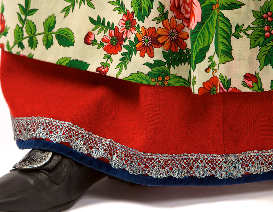 <p> Stakken er i raud ulldamask med kniplingsborder i sølv.  </p>‘ /><img data-image-id=